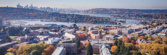 A drone photograph showing campus and the Seattle skyline in fall.