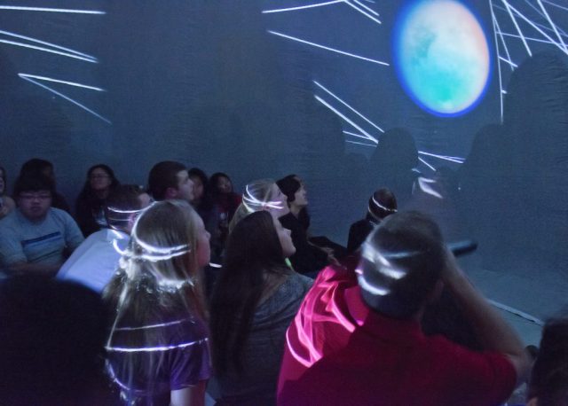Photo of students inside the mobile planetarium for department outreach. 