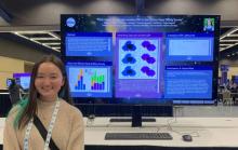 Midori Rollins stands in front of her iPoster titled “Early results on optically-variable AGN in the DECam Deep Drilling Survey.” 