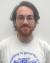 picture of white male, brown hair, glasses, bear, t-shirt that says "reading is good for you"